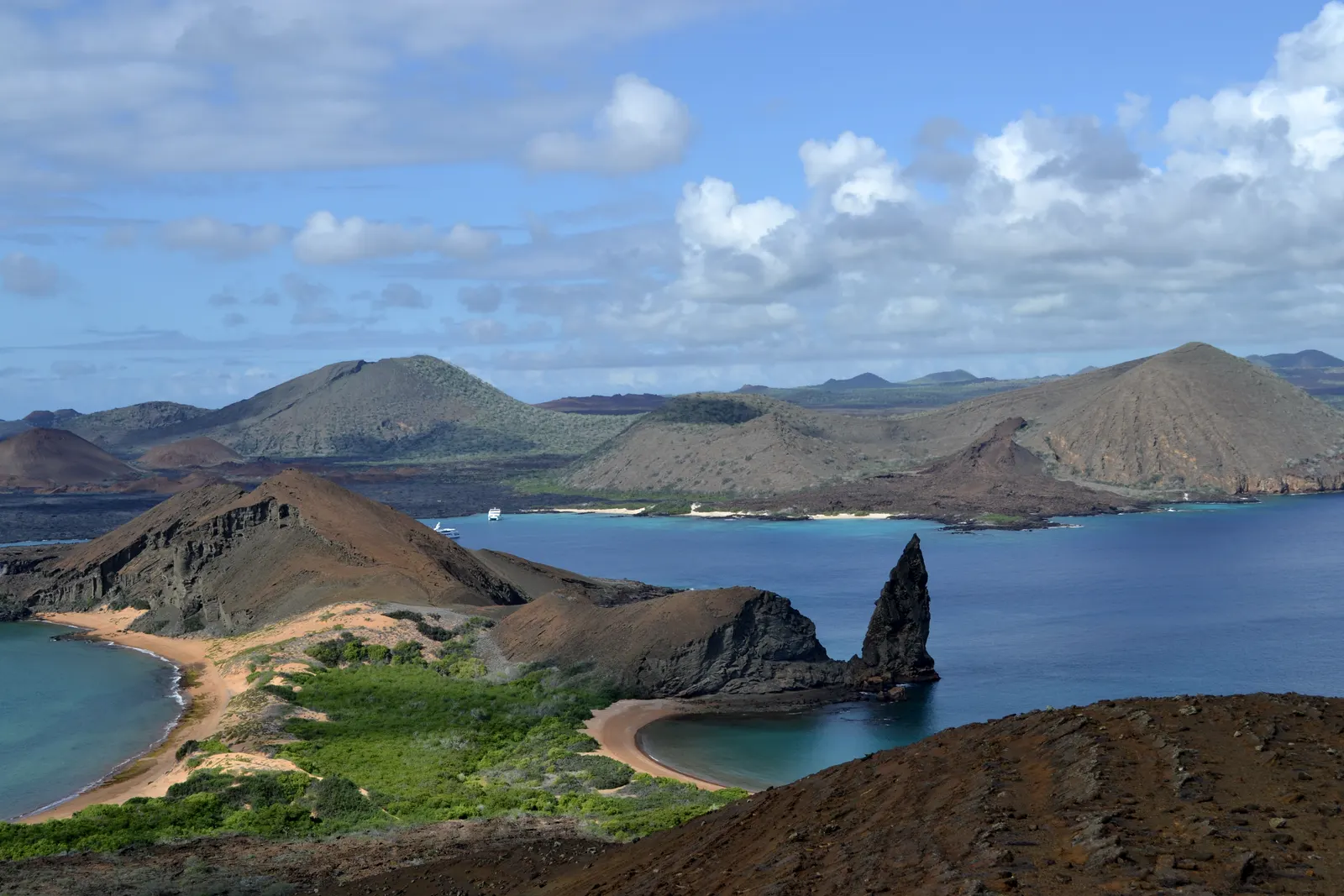 Bartolomé Island in the Galápagos from the summit trail, Pinnacle Rock standing in the bay between two crescent beaches.