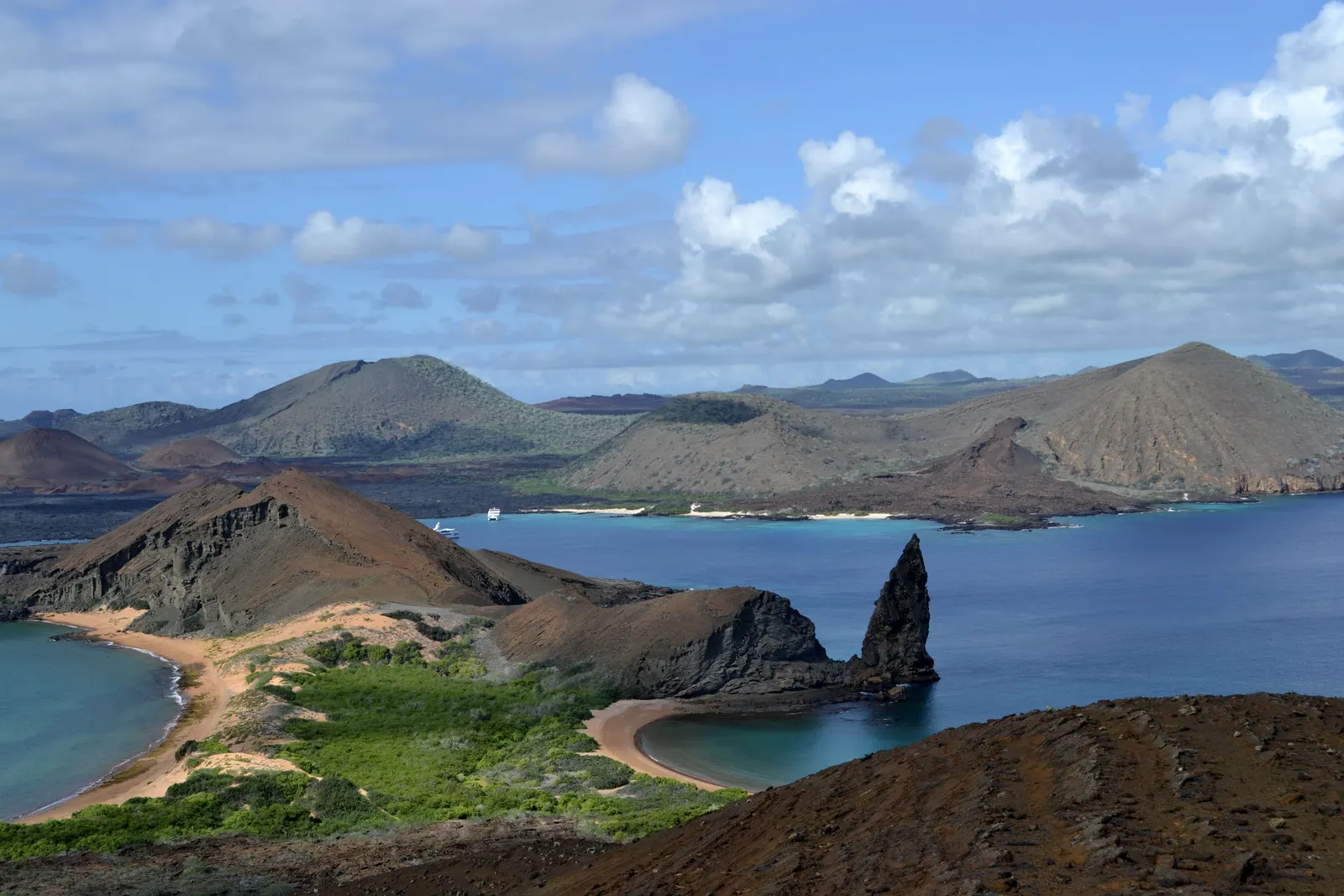 Bartolomé Island in the Galápagos from the summit trail, Pinnacle Rock standing in the bay between two crescent beaches.