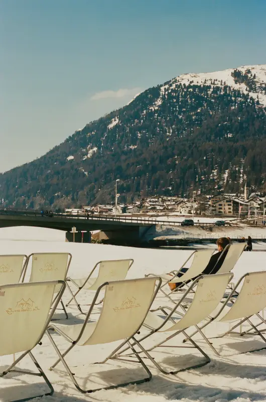 Deck chairs on a terrace above the valley, shot on film.
