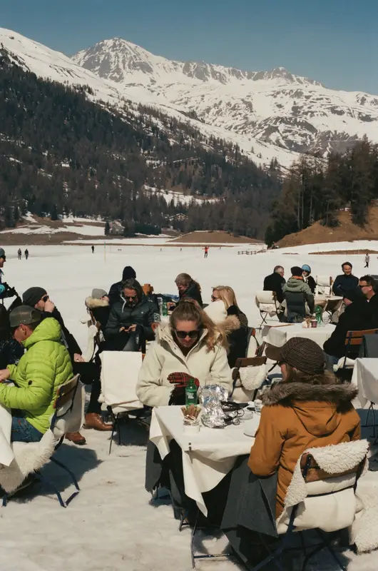 Lunch tables on the snow at St. Moritz, film grain and low winter sun.