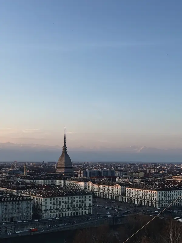 Turin at dusk from above, the Mole Antonelliana standing over the rooftops.